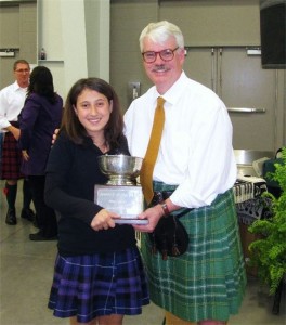 Rachel Clemente is presented with the Harpist of the Day trophy sponsored by the Clan Currie Society